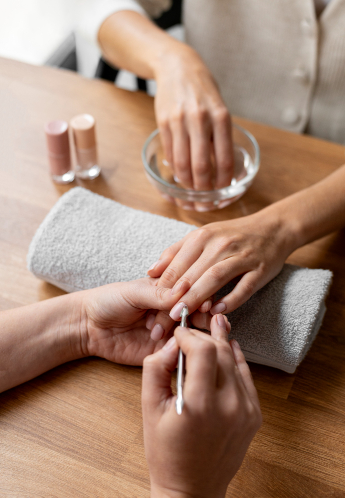 Osoba korzystająca z zabiegu manicure w ośrodku rehabilitacji nad morzem, w ramach turnus&oacute;w rehabilitacyjnych, z relaksującą atmosferą i profesjonalną obsługą.